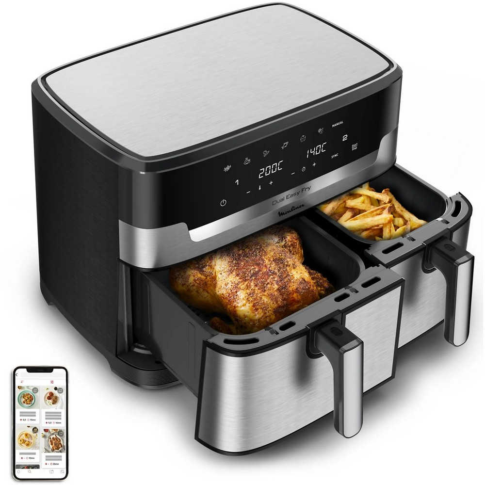Freidora de aire Dual Easy Fry con pollo y patatas fritas dentro. Un teléfono mostrando recetas está al lado.