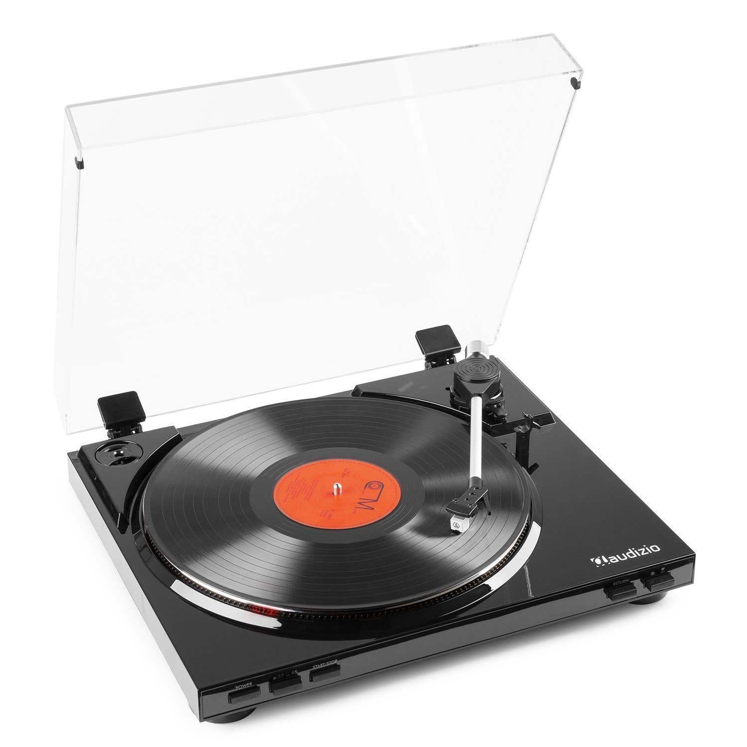 A black record player with a vinyl record playing. A clear plastic cover is open. Buttons and the brand name are visible.
