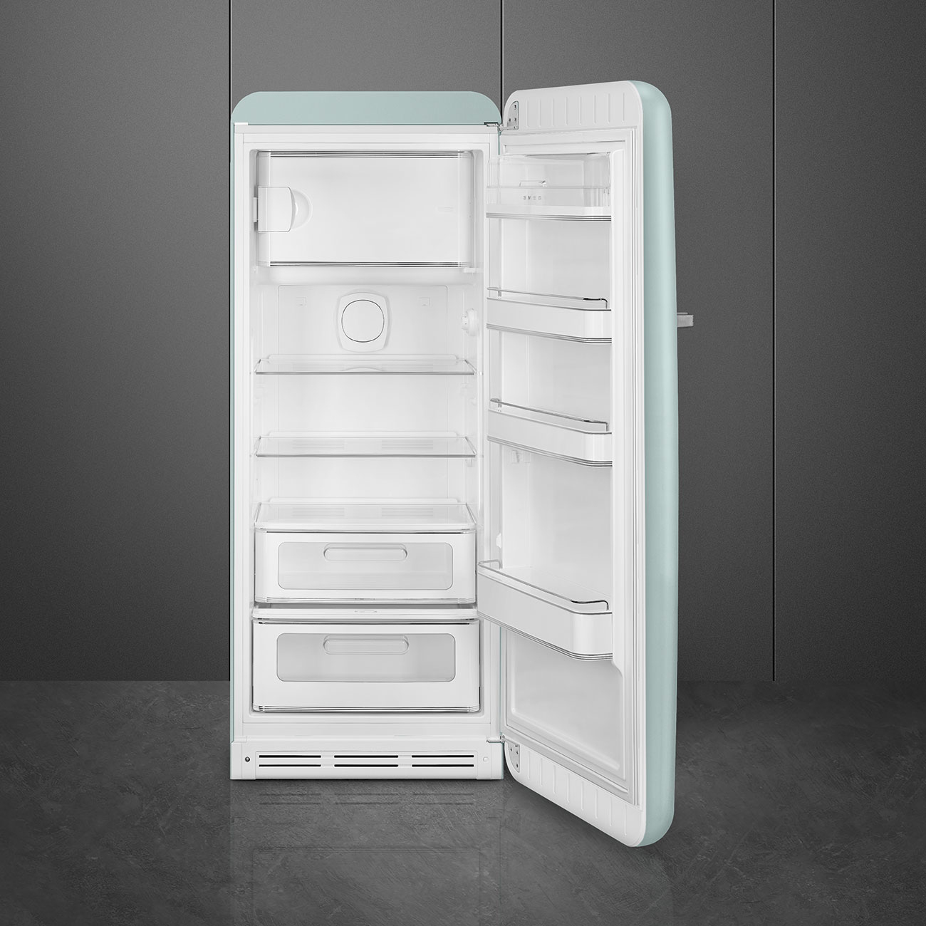 Geöffnete Vintage-Kühlschrank. Mintgrünes Äußeres, weißes Inneres. Regale, Schubladen sichtbar. Dunkelgrauer Hintergrund.