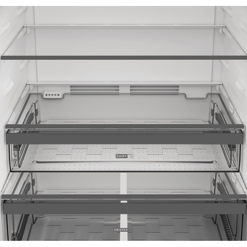 Wnętrze lodówki z półkami i szufladami. Widoczne etykiety 'Dairy' i 'Crisper'. Wnętrze jest białe i szare.