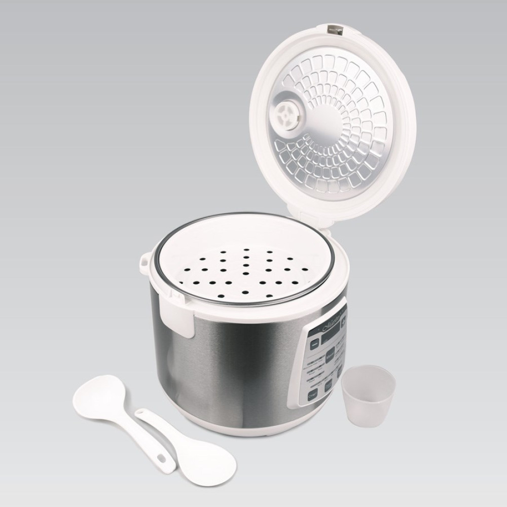 Urządzenie do gotowania ryżu z otwartą pokrywą, koszem do gotowania na parze, dwiema łyżkami i miarką. Obudowa jest srebrna i biała.