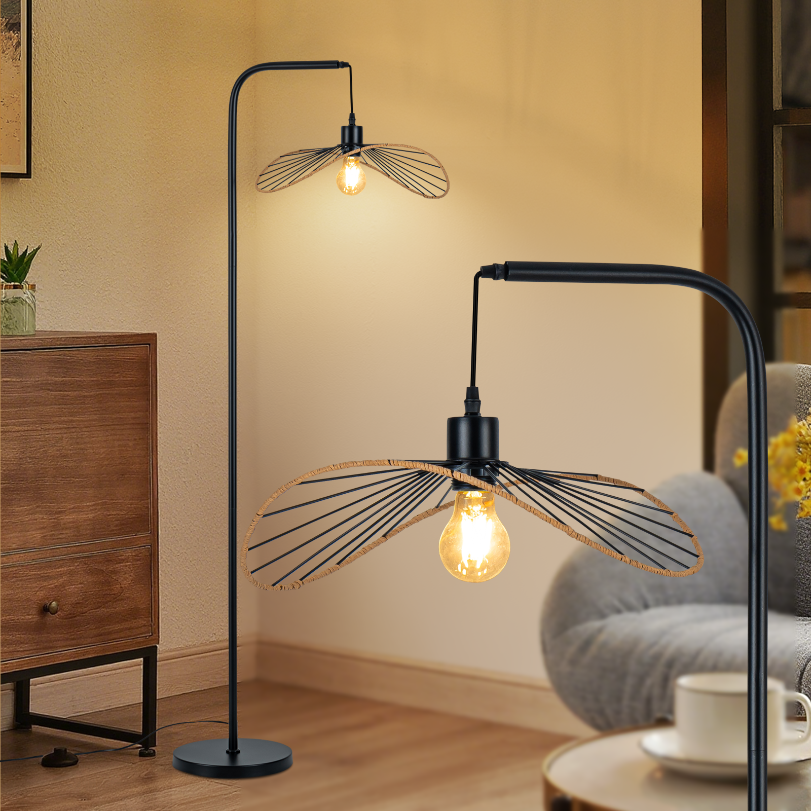Due lampade da terra nere con paralumi, una accesa. Un mobile in legno e un divano grigio sullo sfondo.
