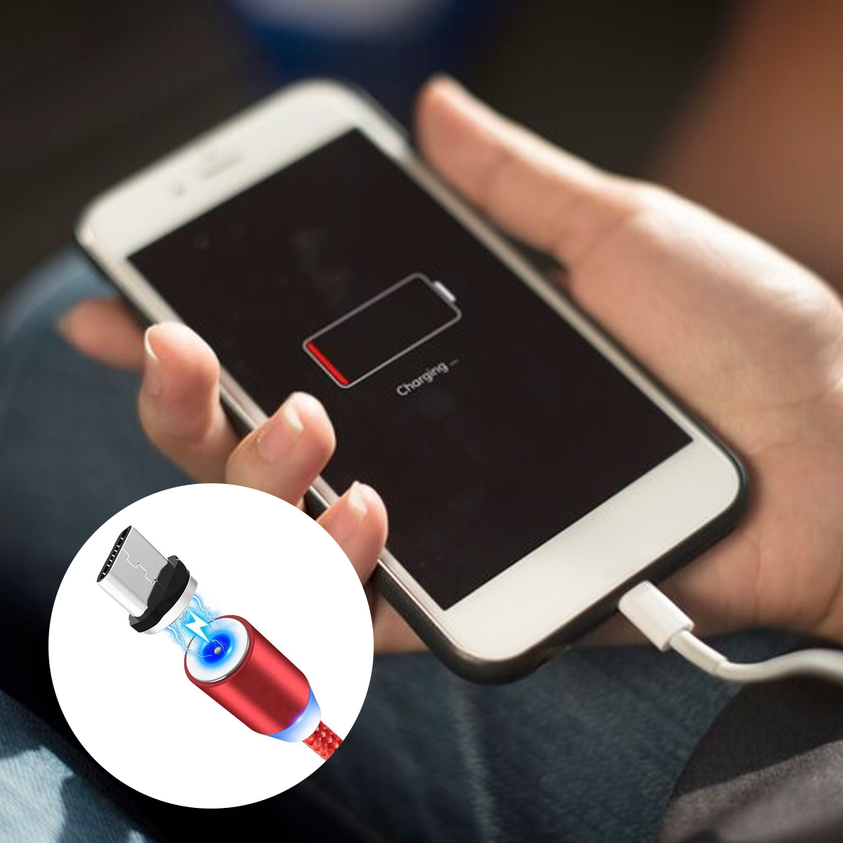 Ein Telefon wird aufgeladen. Es zeigt ein Symbol für schwache Batterie an. Ein rot-weißes Ladekabel ist mit dem Telefon verbunden.