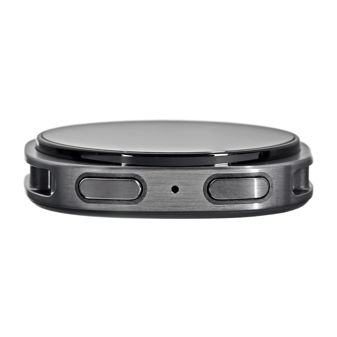 Nahaufnahme einer Smartwatch. Sie hat einen runden, schwarzen Bildschirm. Zwei Knöpfe sind an der Seite, mit einem kleinen Loch dazwischen.