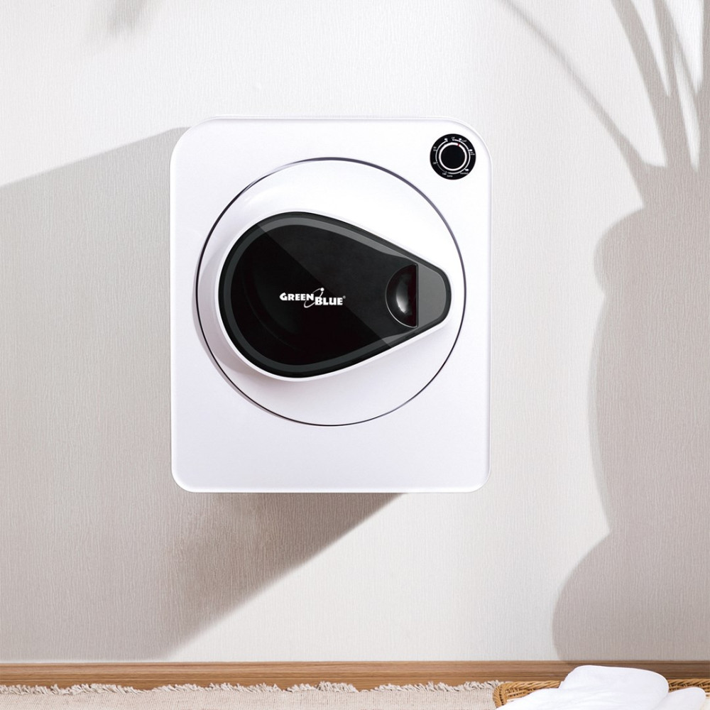 Biała suszarka montowana na ścianie z czarnym panelem wewnętrznym. Cień rośliny rzuca się na ścianę. Na dole kosz z praniem.