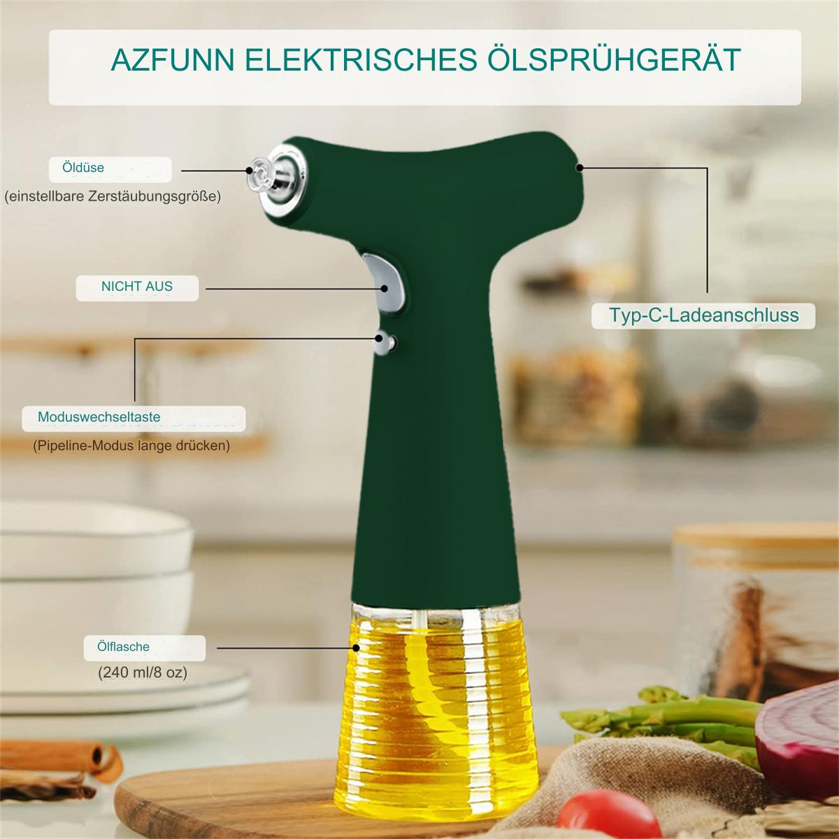 Ein grünes Ölsprühgerät mit einem transparenten Ölbehälter, deutschen Beschriftungen und Gemüse im Hintergrund.