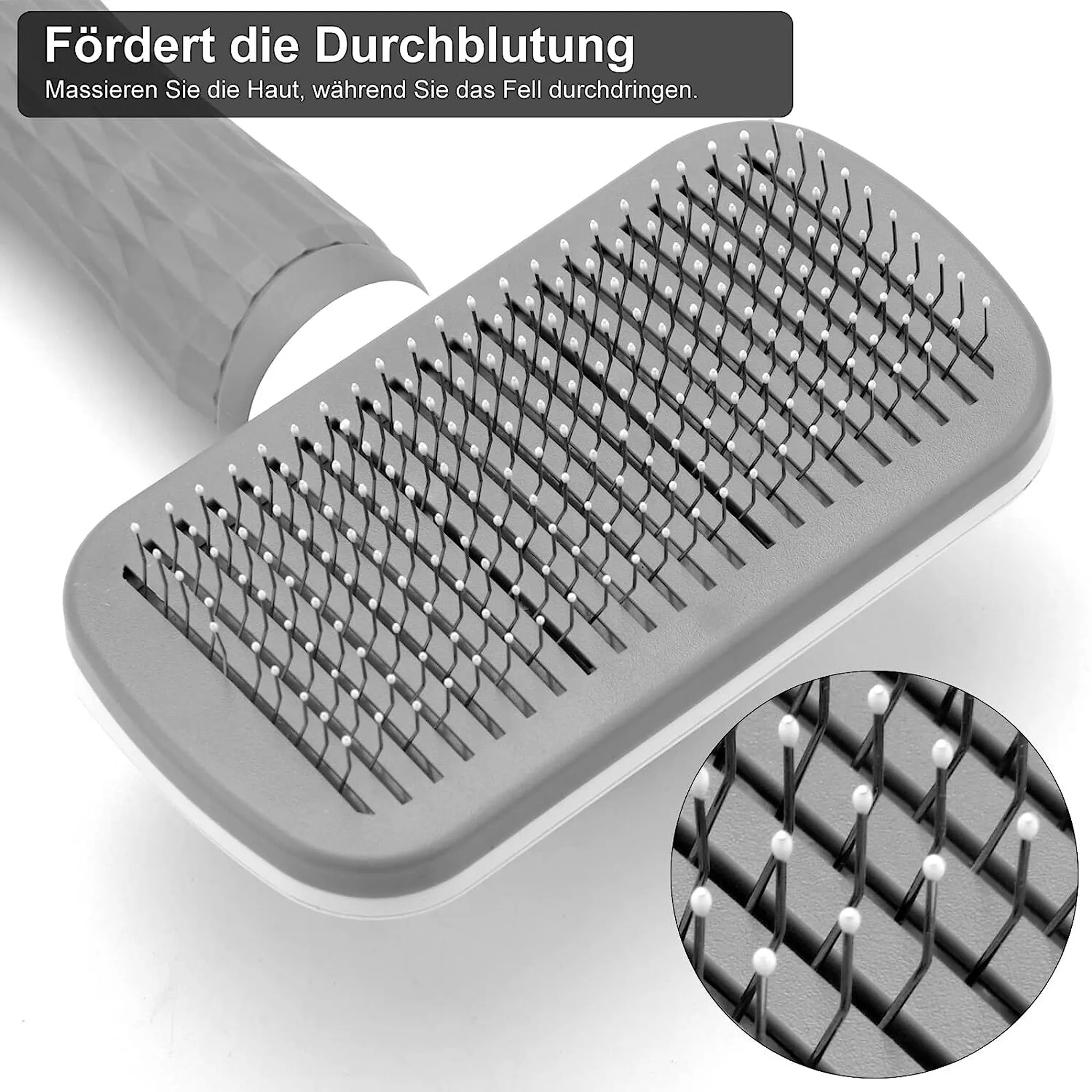 Eine graue Haustierbürste mit weißen Spitzen. Die Bürste hat einen Griff. Nahaufnahme zeigt Borsten und Spitzen. Text auf Deutsch oben.