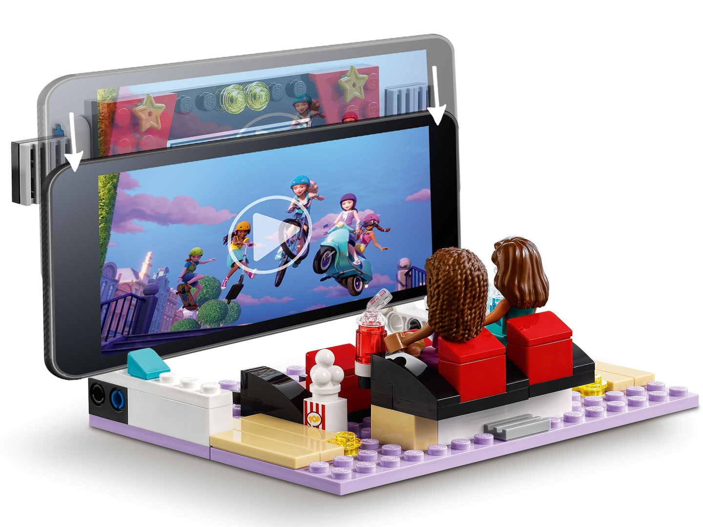 LEGO-Set: Zwei Figuren schauen sich ein Video auf einem Tablet an. Das Video zeigt Zeichentrickfiguren auf Rollern und Skateboards.