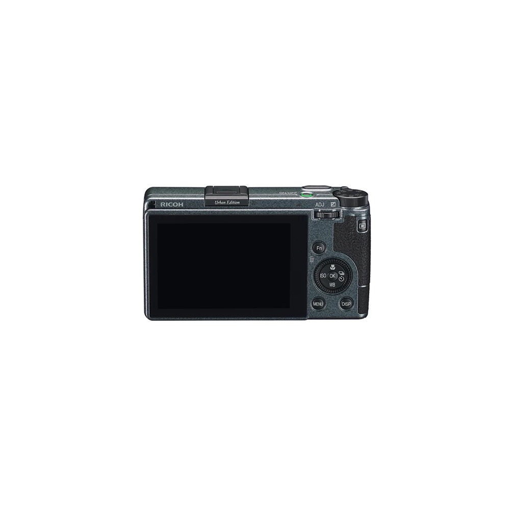 Un appareil photo Ricoh Urban Edition est centré. Il possède un écran noir et des boutons. Le fond est blanc.