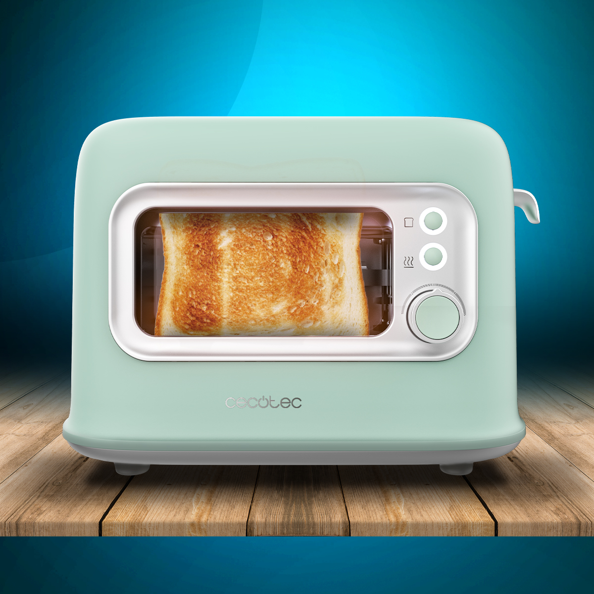 Miętowy toster z kromką tostowanego chleba w środku. Stoi na drewnianej powierzchni na niebieskim tle.