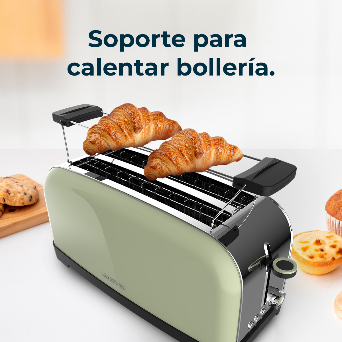 Un tostapane verde con due croissant sopra. Altri prodotti da forno sono ai lati. Testo in alto: 'Soporte para calentar bollería.'