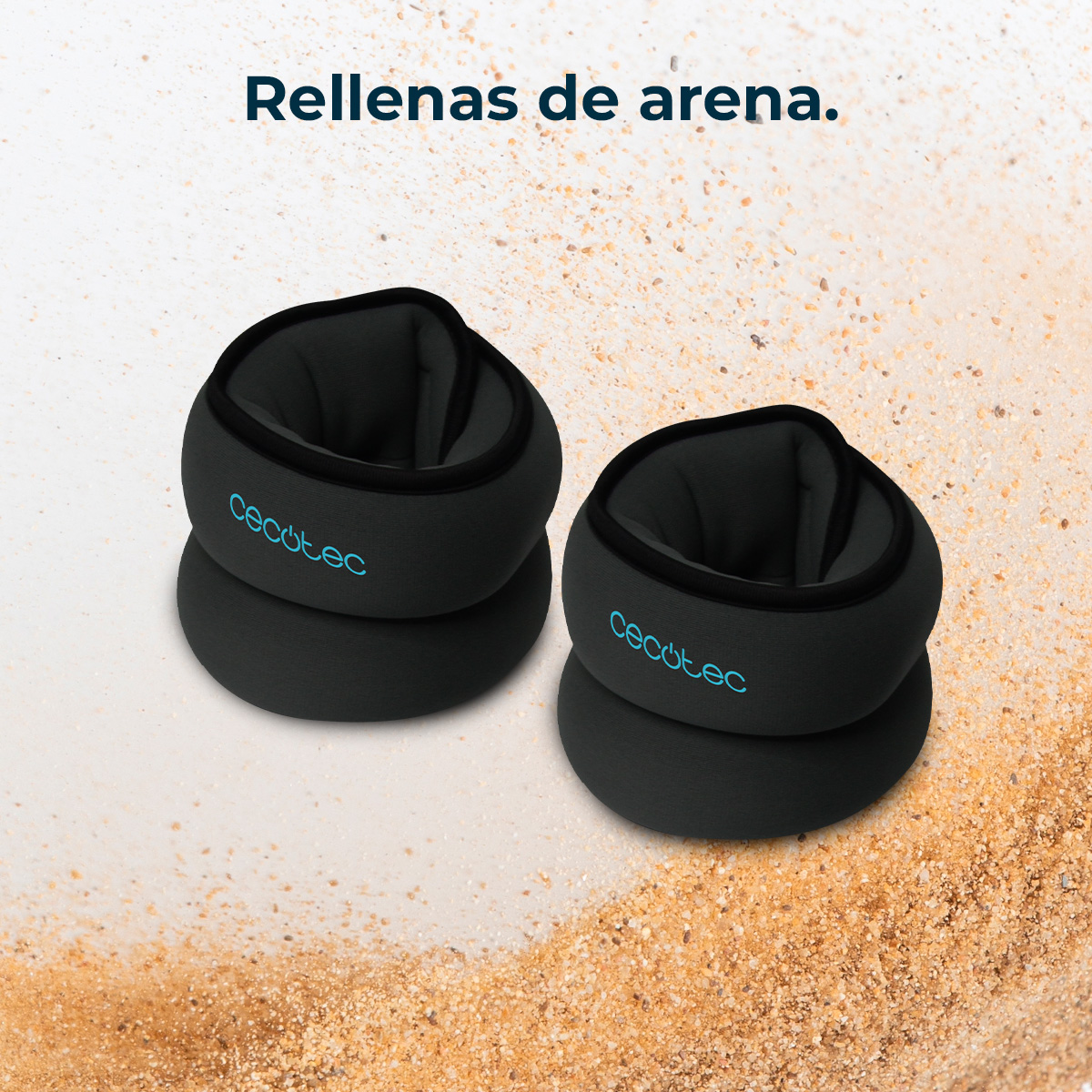 Dos tobilleras negras con el logo 'Cecotec' sobre una superficie arenosa. El texto superior dice 'Rellenas de arena'.