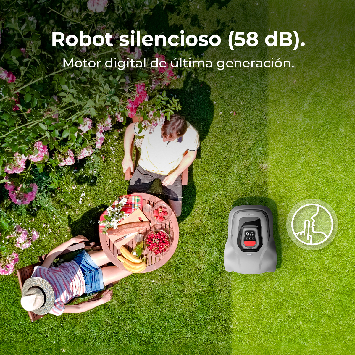 Una escena de picnic en un jardín, con gente relajándose. Un cortacéspedes robótico está en el césped. La mesa tiene comida y bebidas.