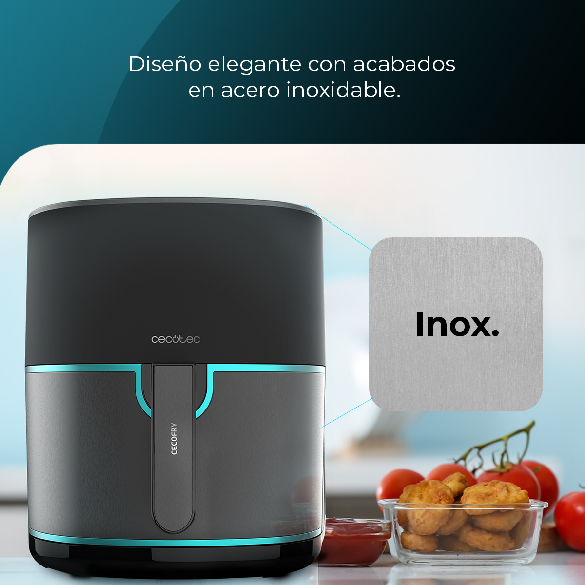 Una freidora de aire negra y gris con detalles azules. En el fondo hay nuggets, tomates y ketchup. Un cuadrado de metal dice "Inox".