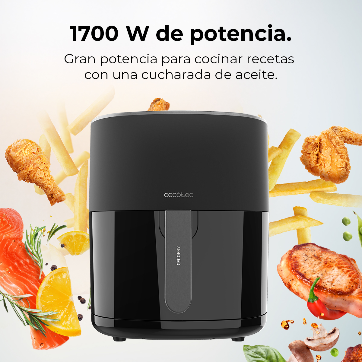 Una freidora de aire negra con pollo frito, papas fritas y otros alimentos. El texto dice: 1700 W de potencia para cocinar recetas con una cucharada de aceite.