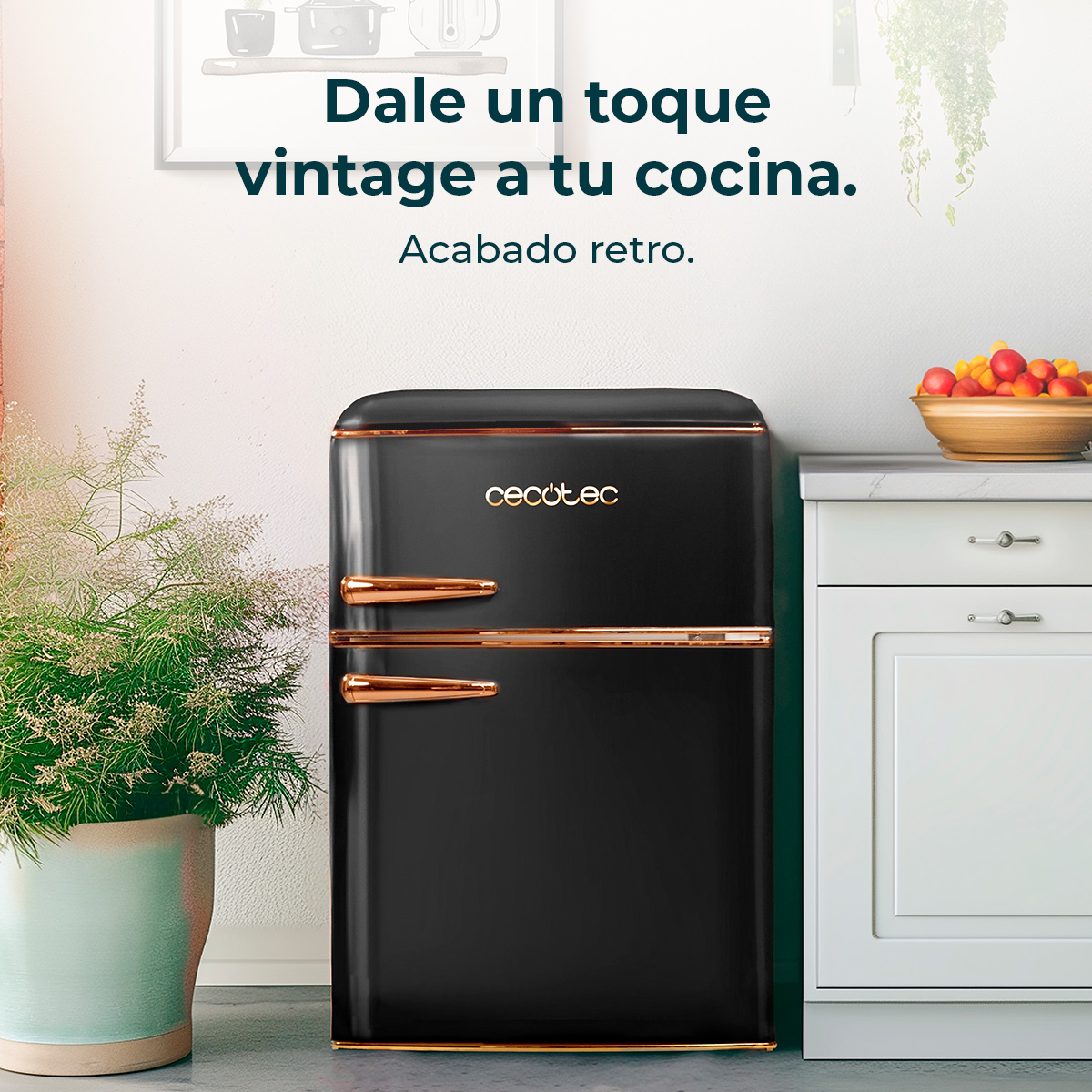 Czarna lodówka w stylu retro ze złotymi akcentami. Doniczkowa roślina po lewej, owoce w misce po prawej. Tekst: kuchnia w stylu vintage.