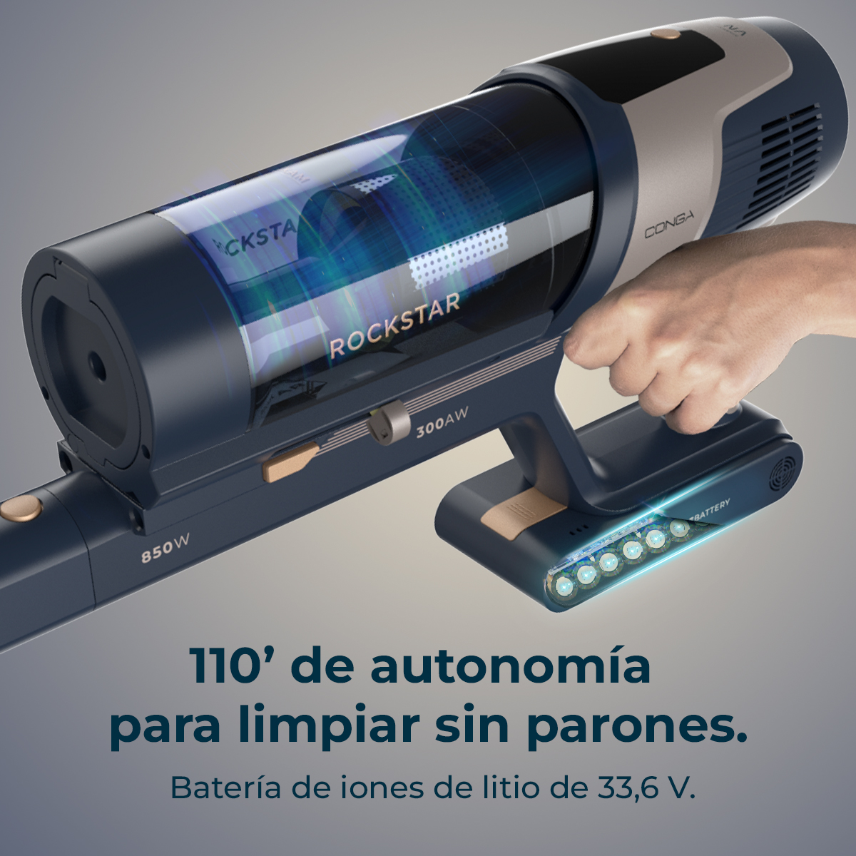 A handheld vacuum cleaner is held by a hand. The vacuum is navy blue and silver with the word 'ROCKSTAR' visible.