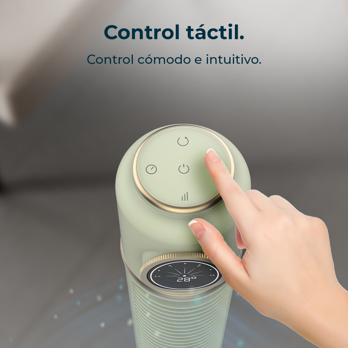 A hand touches a button on a green and gold device. The device has a digital display and control buttons. The background is blurred.