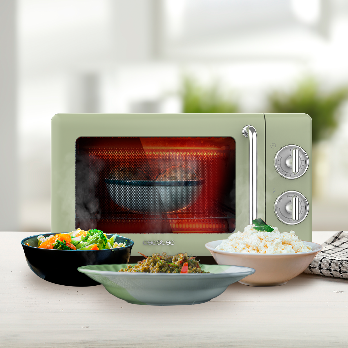 Zielona kuchenka mikrofalowa z miskami jedzenia przed nią. Wewnątrz miska paruje. Różne dania: warzywa, ryż i mieszany talerz.