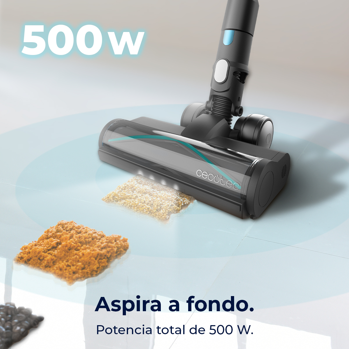 Una aspiradora negra y gris está limpiando escombros. Las palabras "500W" están en la parte superior. Las palabras "Aspira a fondo" están abajo.