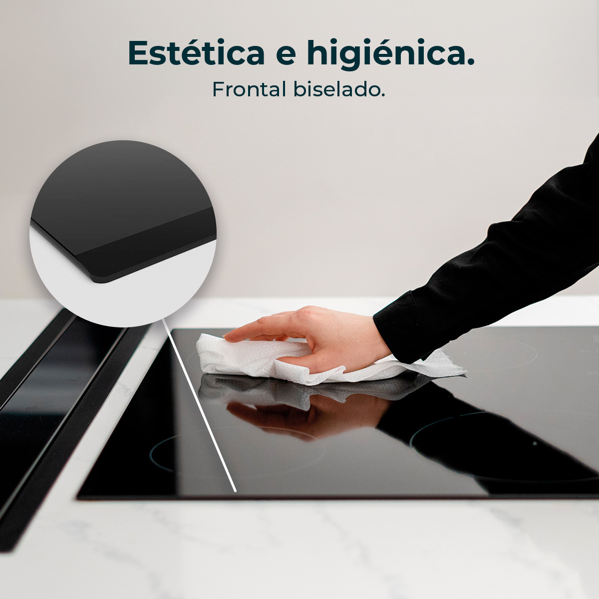 Ręka wyciera czarną płytę kuchenną białą szmatką. Okrągła wstawka pokazuje zbliżenie krawędzi płyty. Tekst mówi „Estética e higiénica”.