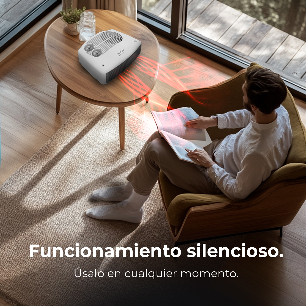 Mężczyzna czyta książkę w fotelu. Grzejnik na stole emituje czerwone ciepło. Scena rozgrywa się w pomieszczeniu przy oknie.