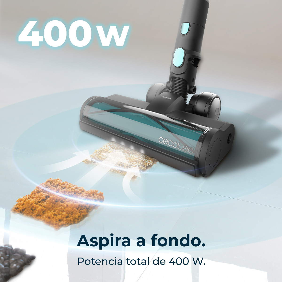Una aspiradora limpiando escombros en una superficie azul claro. La aspiradora es negra con detalles en verde azulado. El texto dice: 400W.