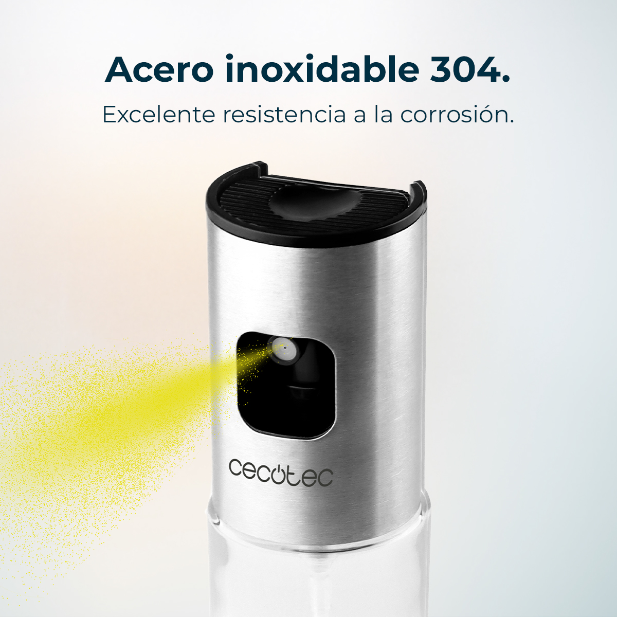 Una botella de spray de acero inoxidable. Sale un rocío amarillo. El texto superior dice acero inoxidable.
