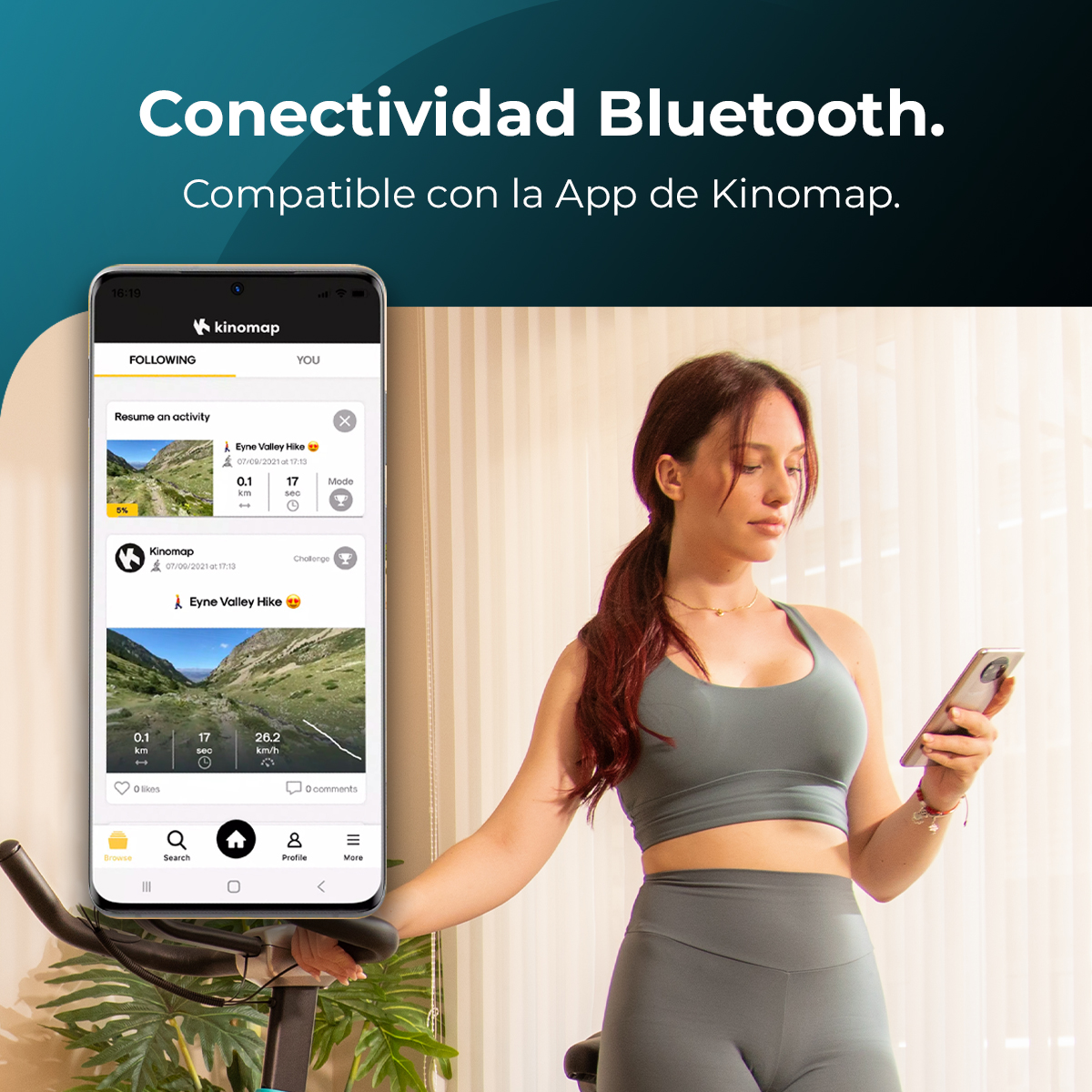 Una mujer usa un teléfono en una bicicleta estática. El teléfono muestra una app. Texto: 'Conectividad Bluetooth' y 'Compatible con la App de Kinomap'.