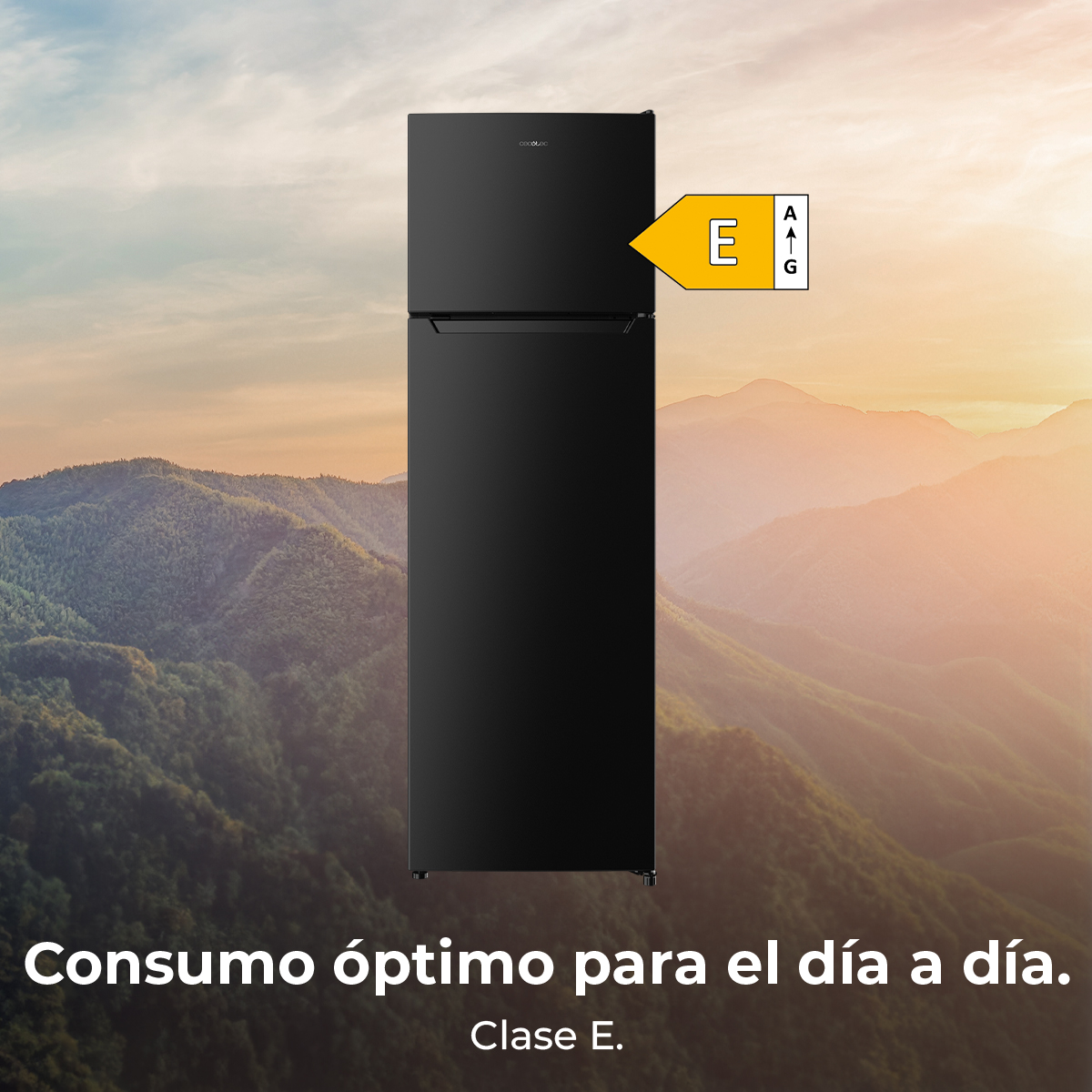 Un frigorifero nero con etichetta energetica E. Montagne e tramonto sullo sfondo. Testo spagnolo in basso.
