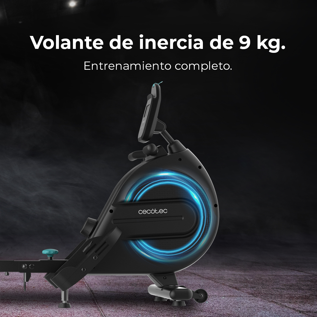 Máquina de remo negra con círculo brillante azul. El texto dice 'Volante de inercia de 9 kg. Entrenamiento completo'.