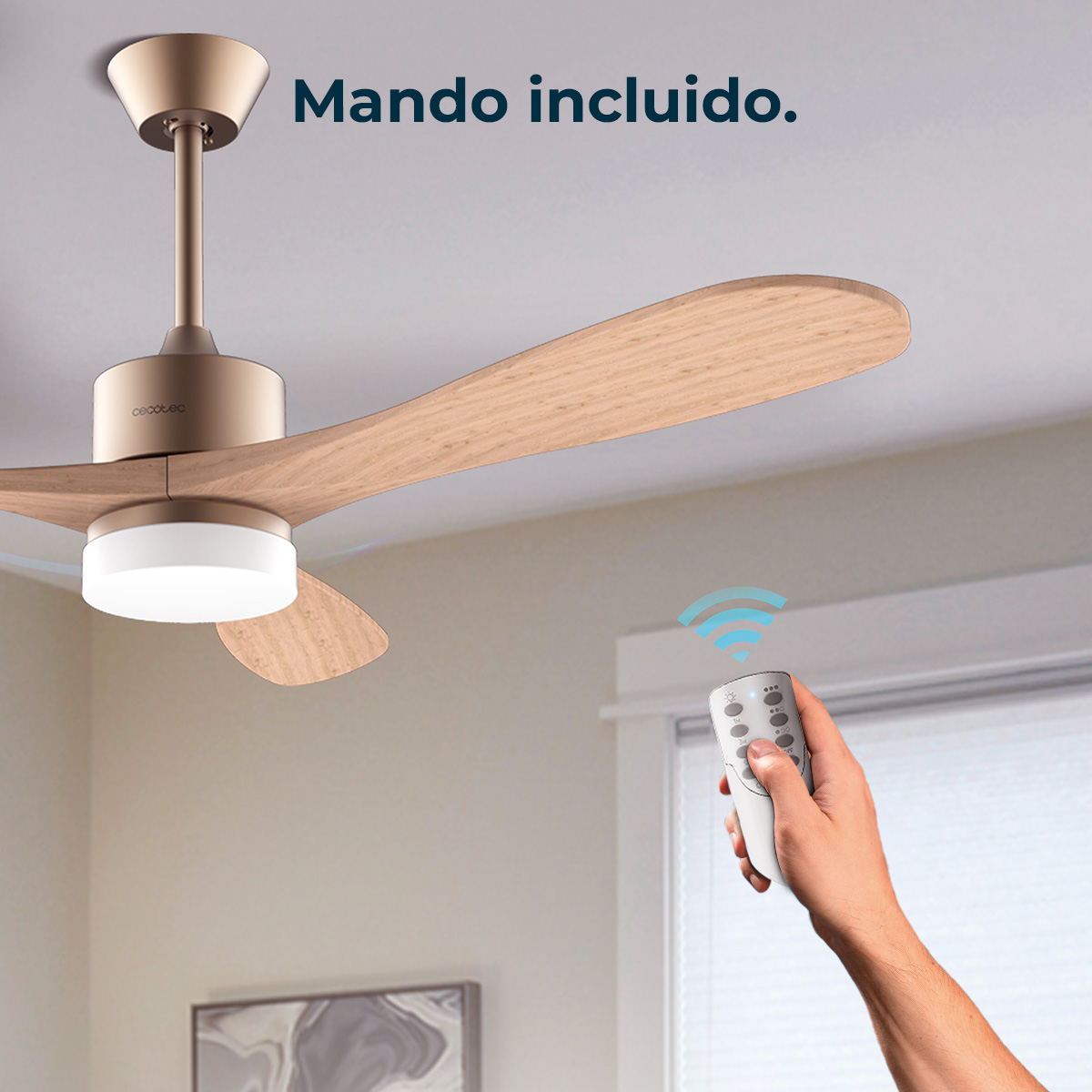 Pokazano wentylator sufitowy z drewnianymi łopatkami. Dłoń z pilotem wysyła sygnał. Tekst: 'Mando incluido'.