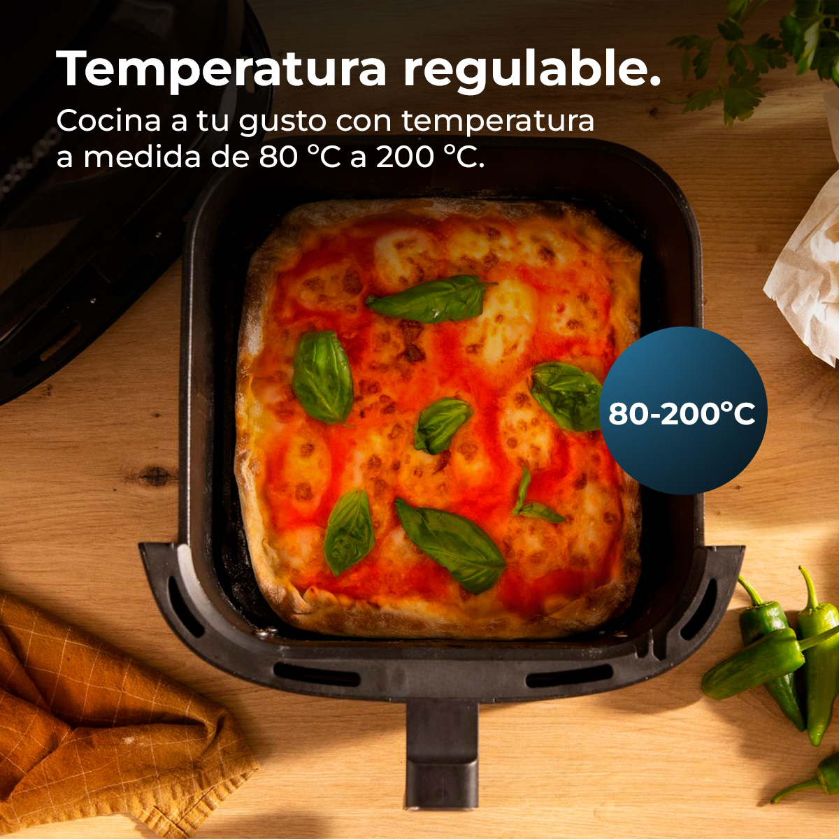 Een pizza in een airfryer met basilicumblaadjes. Tekst: instelbare temperatuur, kook naar wens van 80°C tot 200°C.