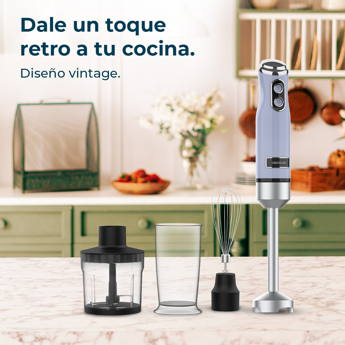 Una scena di cucina dal design retrò. Un frullatore a immersione blu, un bicchiere, una frusta e un contenitore nero sono su un piano di marmo.