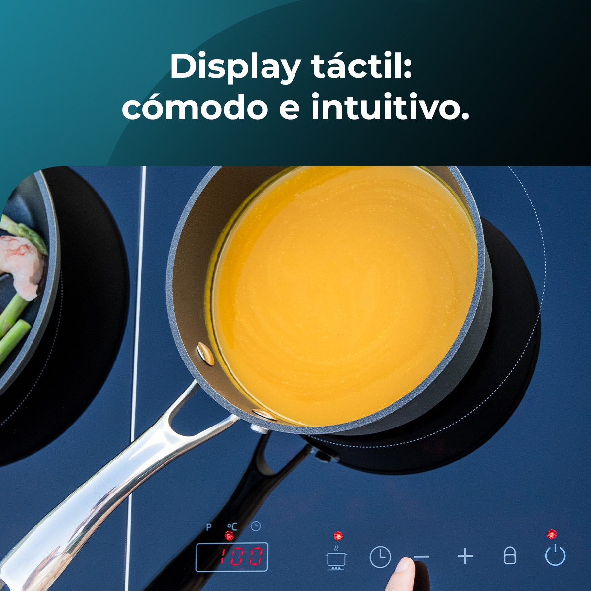 Garnek zupy na czarnej płycie kuchennej. Wyświetlacz cyfrowy pokazuje 100 stopni. Tekst: Display táctil: cómodo e intuitivo.