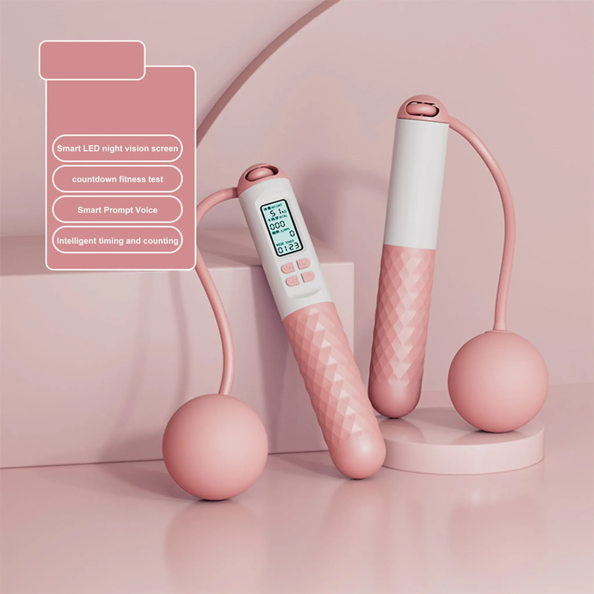 Zwei rosa Springseile auf rosa Oberfläche. Eines steht auf einer kleinen Plattform. Merkmale umfassen einen LED-Bildschirm.