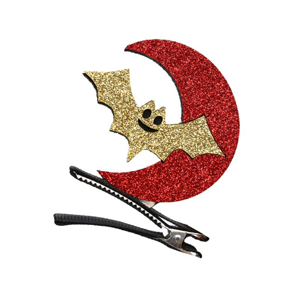 Haarspange mit glitzerndem, rotem Halbmond und goldener Fledermaus, mit schwarzem und silbernem Clip.