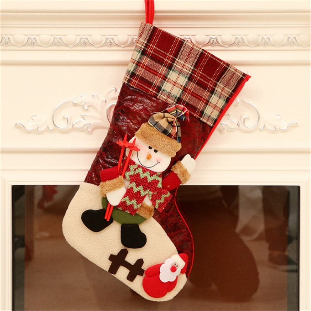 Ein Weihnachtsstrumpf mit einem Schneemann mit Hut und Schal und einem Weihnachtsmann unten.