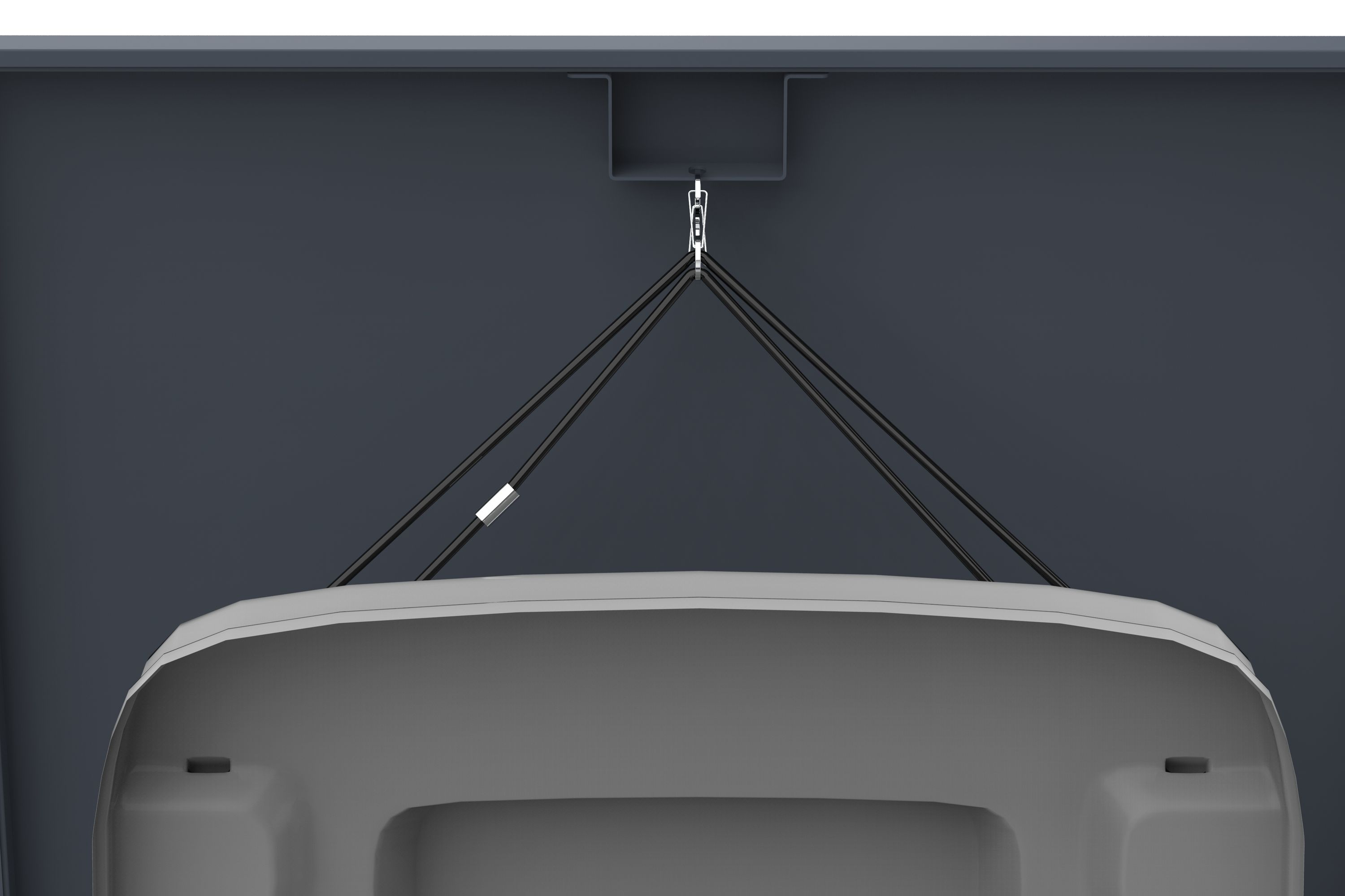 Ein graues Objekt wird von der Decke durch schwarze Kabel abgehängt. Der Hintergrund ist dunkelgrau.