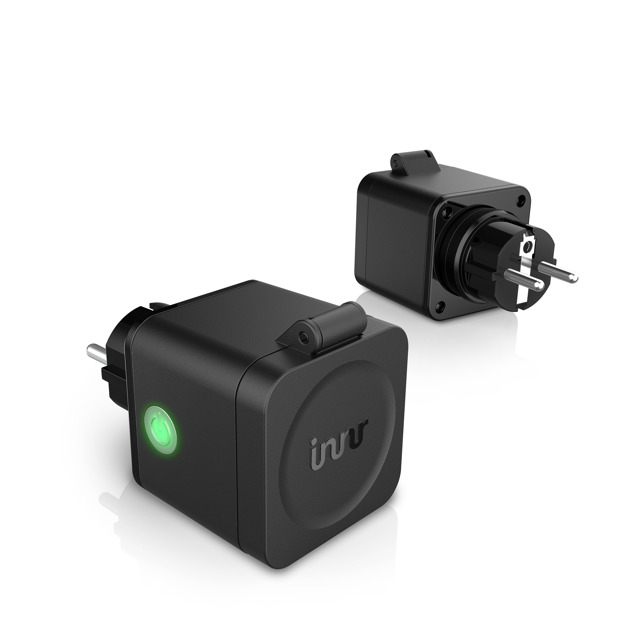 Two black smart plugs on a black background. One plug has a green light. The other plug's prongs are visible.