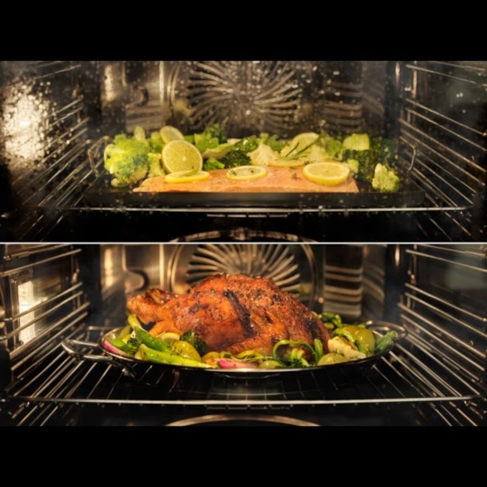 Forno con due teglie. La teglia superiore ha salmone, broccoli e fette di limone. La teglia inferiore ha pollo arrosto con verdure.