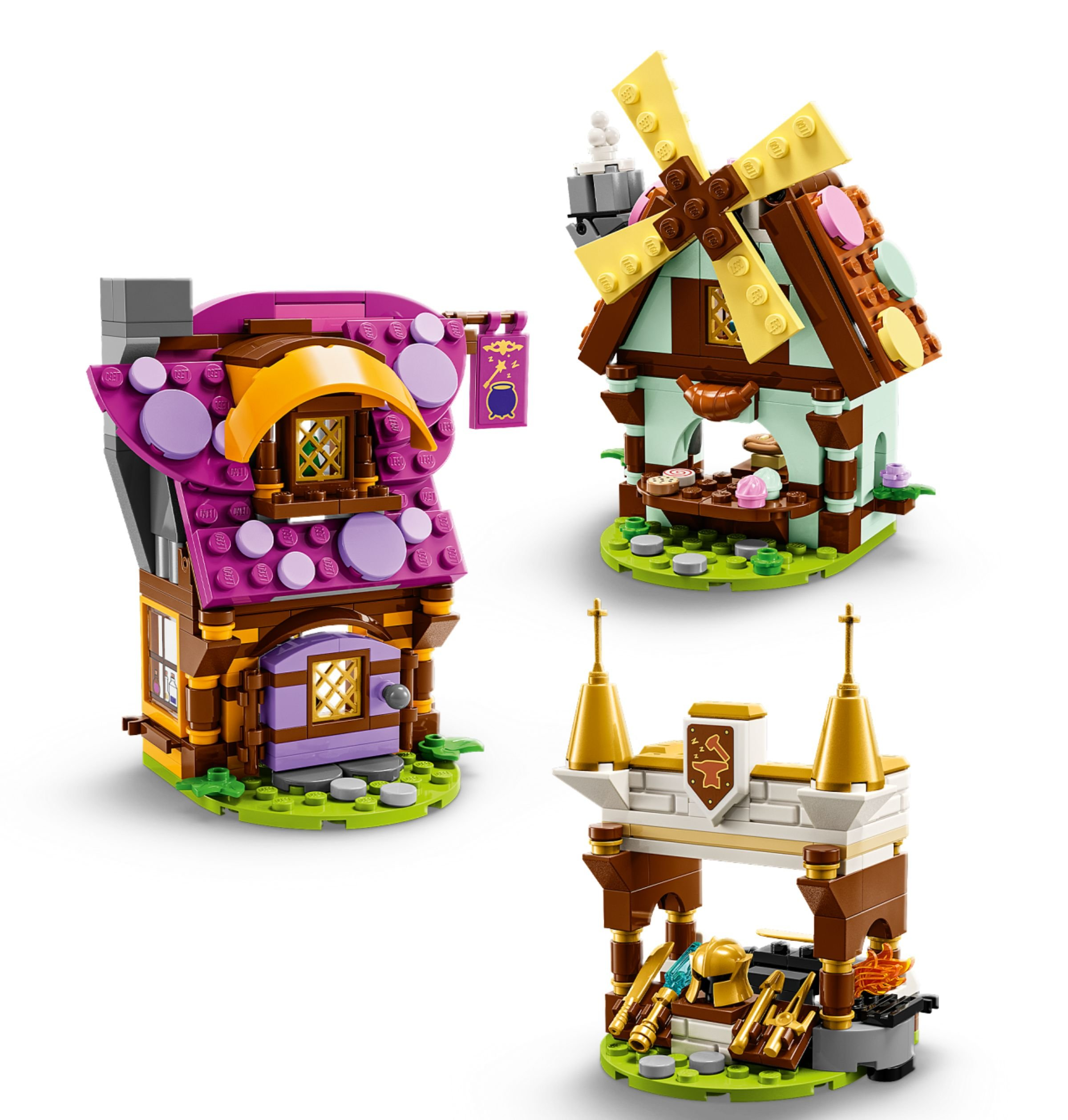 Drei Lego-Gebäude: ein Haus mit lila Dach, eine Windmühle und eine burgähnliche Struktur. Alle auf grünen Sockeln.