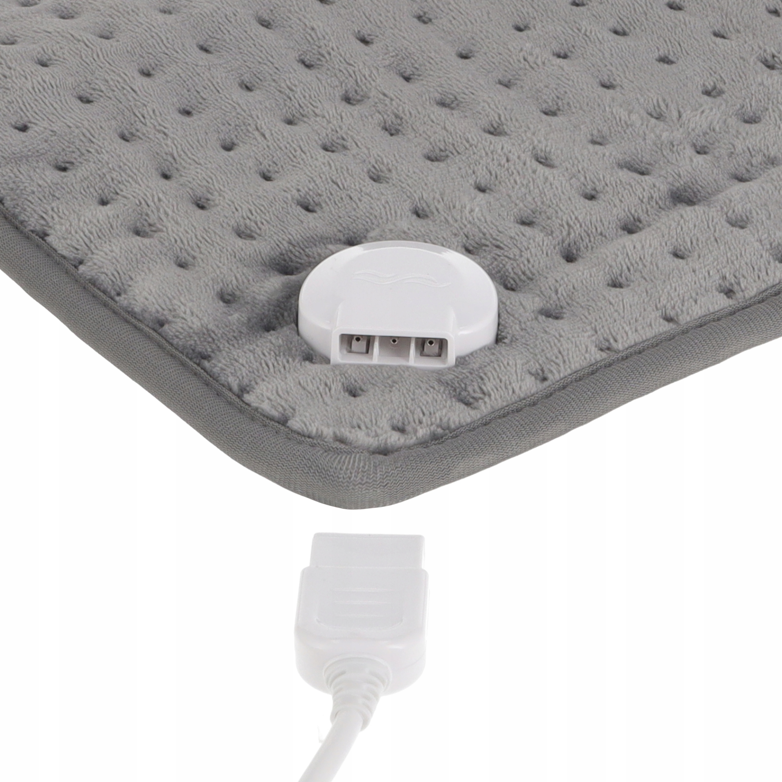 Szara poduszka grzewcza z białym złączem i wtyczką. Podkładka ma teksturowaną powierzchnię z białym sterowaniem.