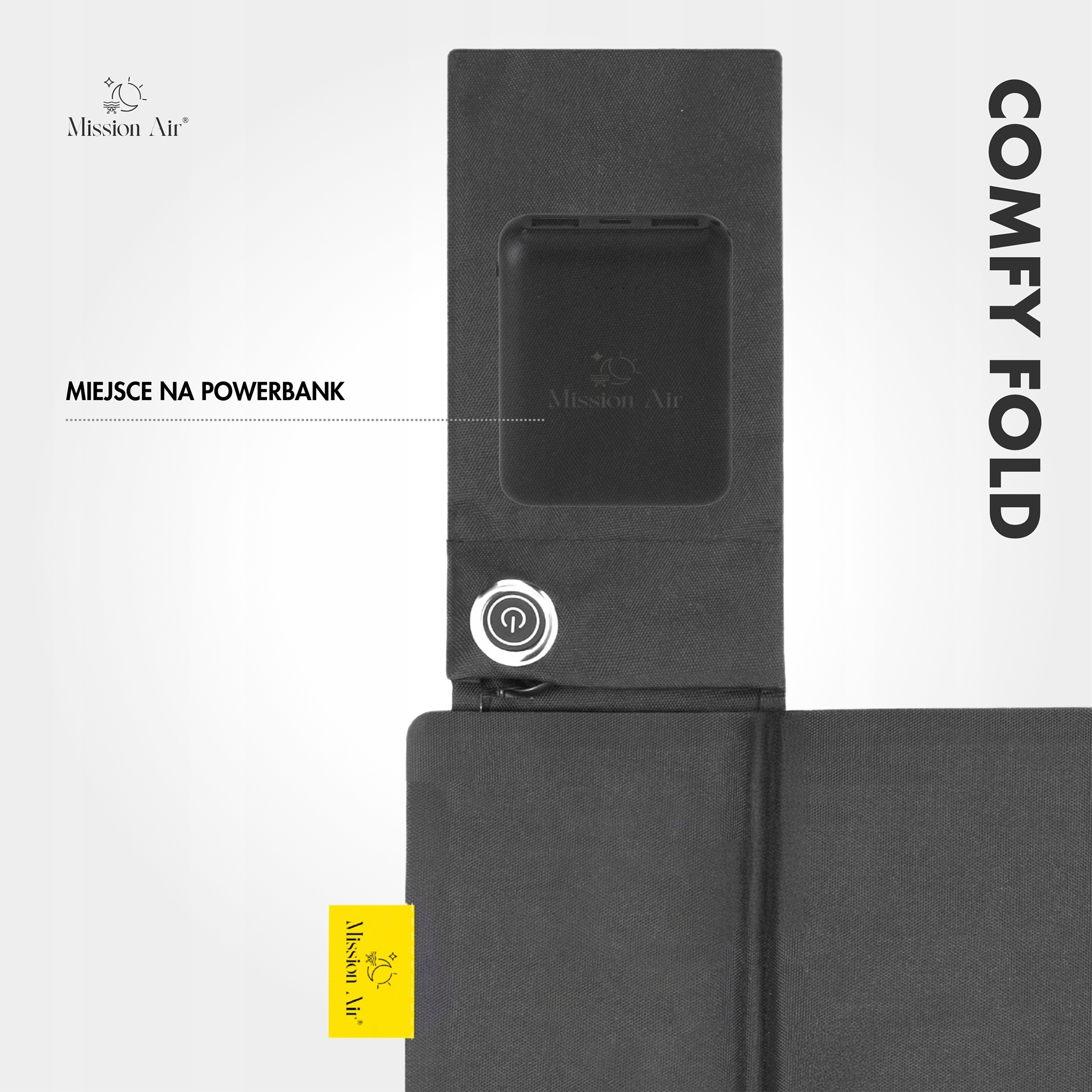 Czarny uchwyt na power bank Comfy Fold, z przyciskiem zasilania i żółtym logo Mission Air. Tło jest białe.