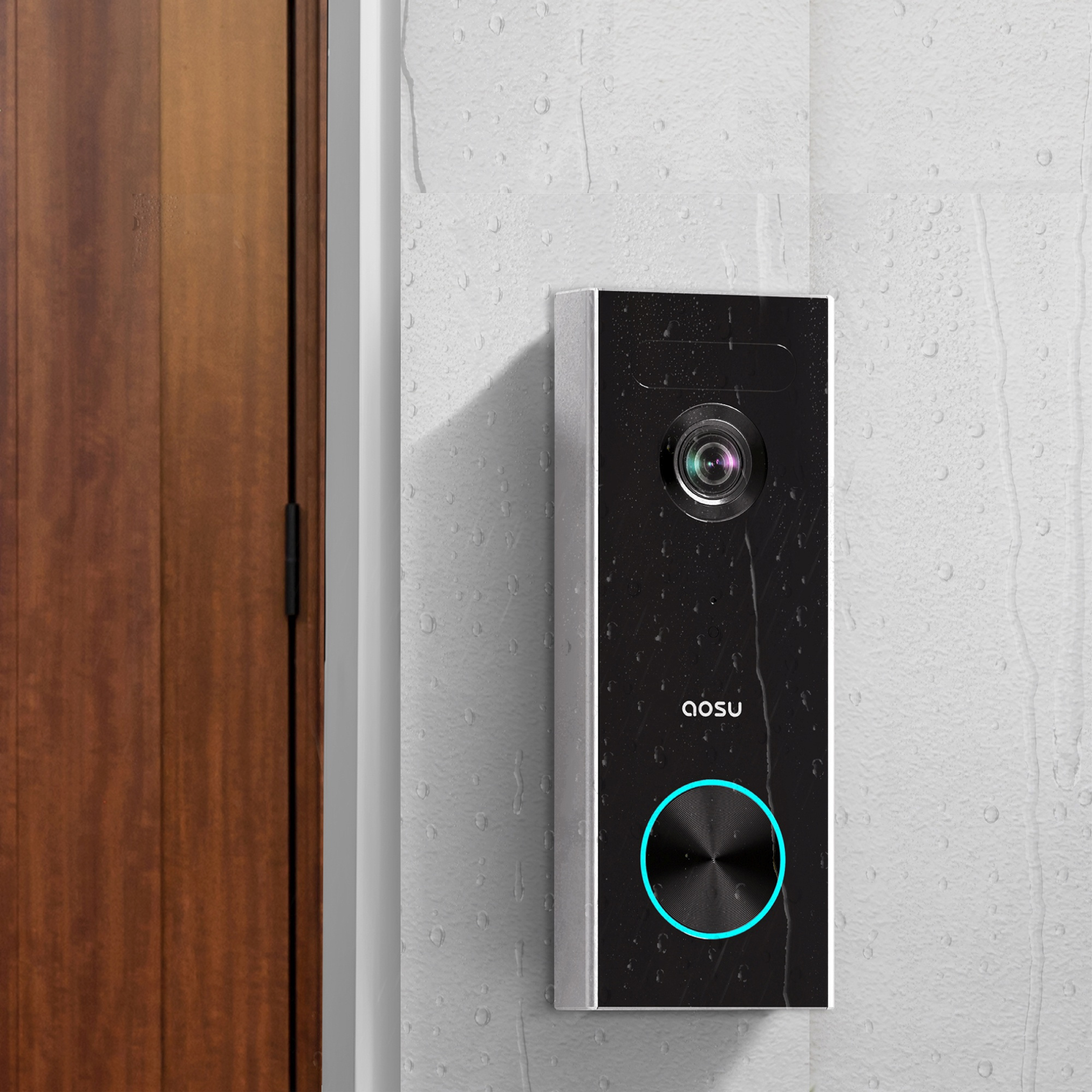 A black doorbell with a camera and a blue light is mounted on a textured white wall next to a wooden door.