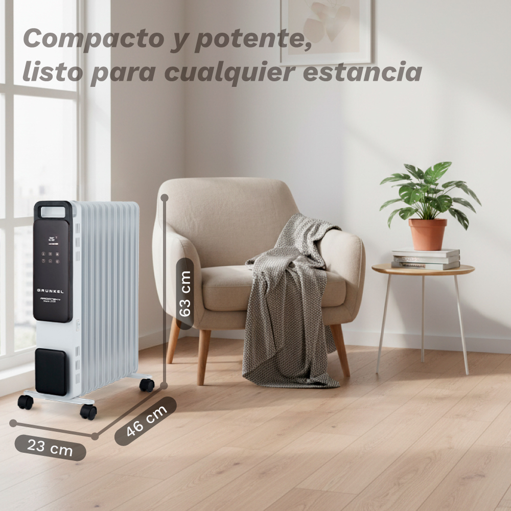 Un radiador de aceite blanco, un sillón con una manta, una mesa auxiliar con una planta y suelo de madera son visibles.