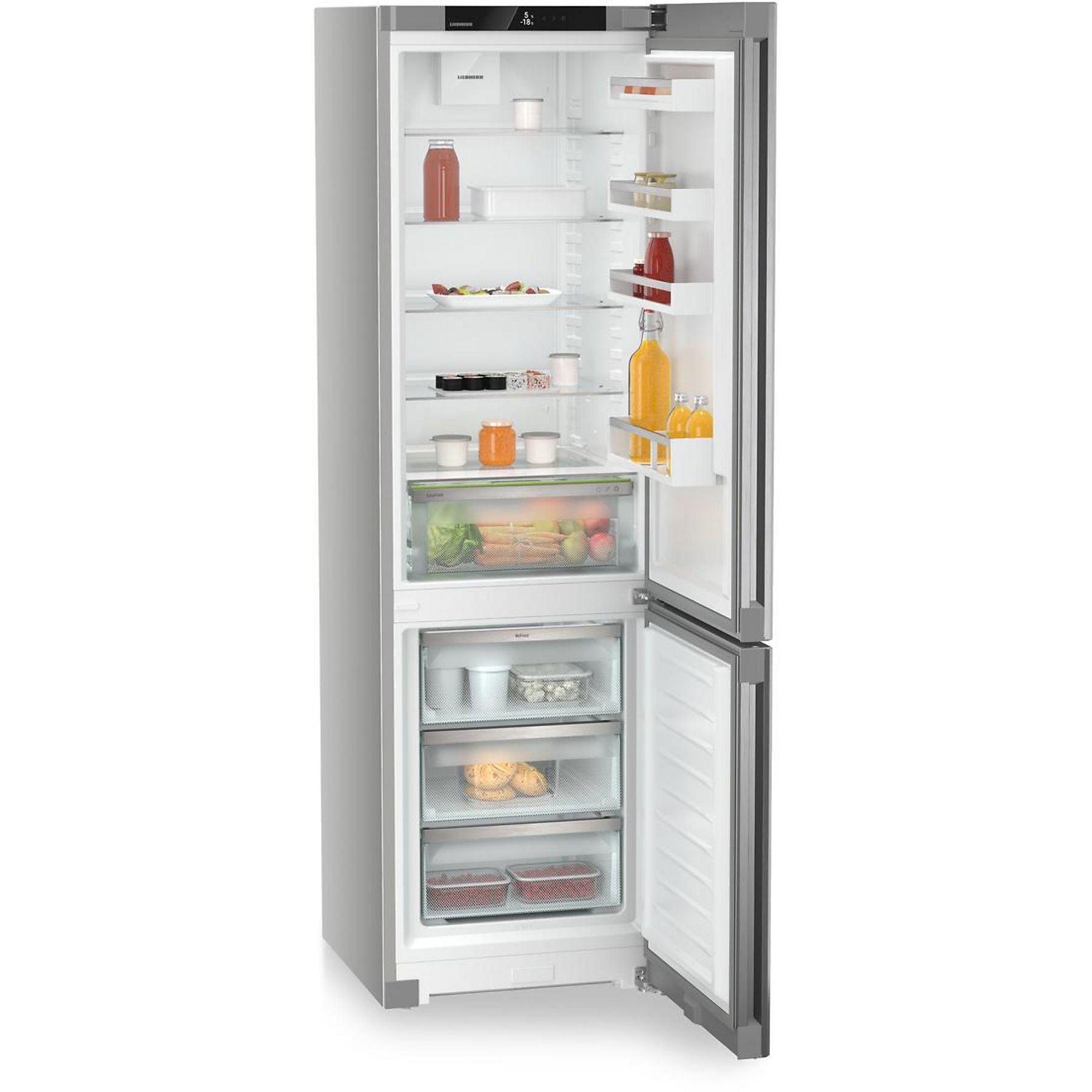 Refrigerador abierto lleno de alimentos, incluyendo frutas, verduras, bebidas y recipientes. La puerta está abierta.