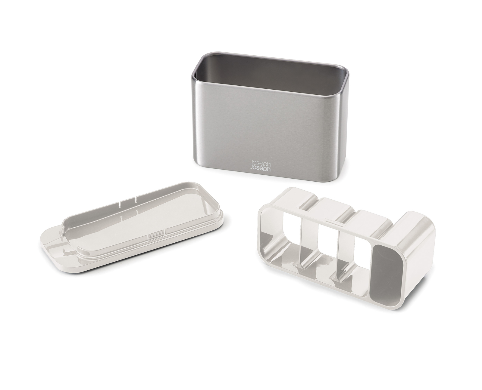 Juego de utensilios de cocina de tres piezas: un recipiente de acero inoxidable, una bandeja blanca y un organizador blanco, sobre fondo blanco.