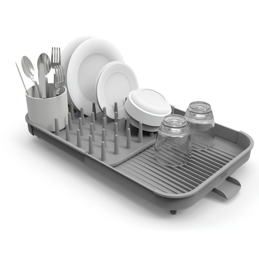 Un escurreplatos gris sostiene platos, utensilios y vasos limpios. Los platos blancos están en el estante, con cubiertos en una taza.