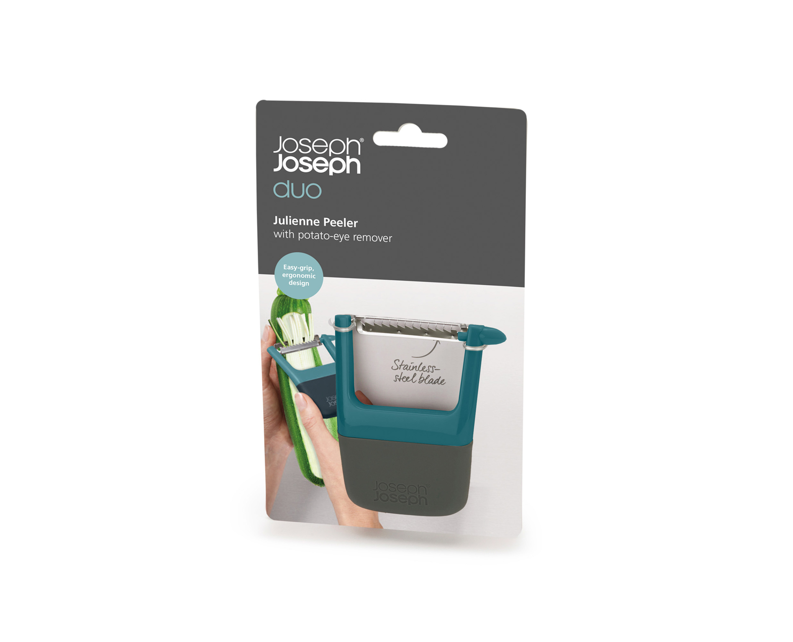 Un pelador Julienne Duo de Joseph Joseph en embalaje, verde azulado y gris, con un calabacín pelándose. La cuchilla es de acero inoxidable.